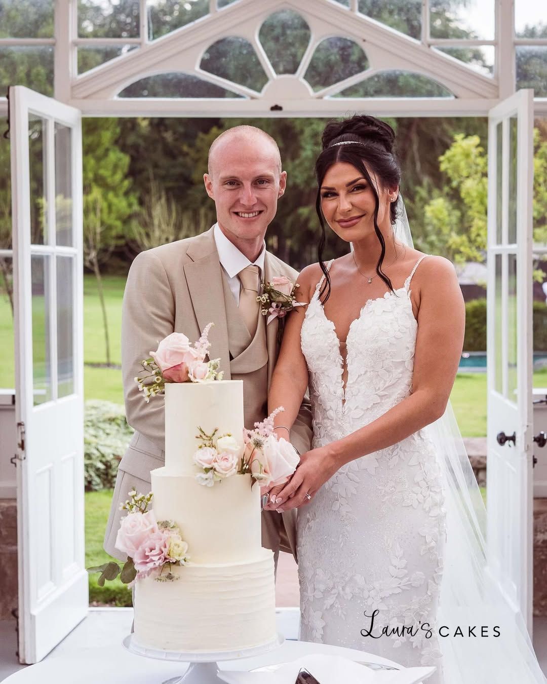 1-a-bride-and-groom-cutting-their-wedding-cake-3