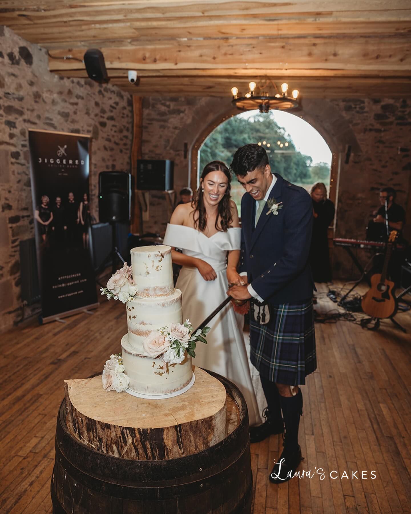 1-a-bride-and-groom-cutting-their-wedding-cake-4