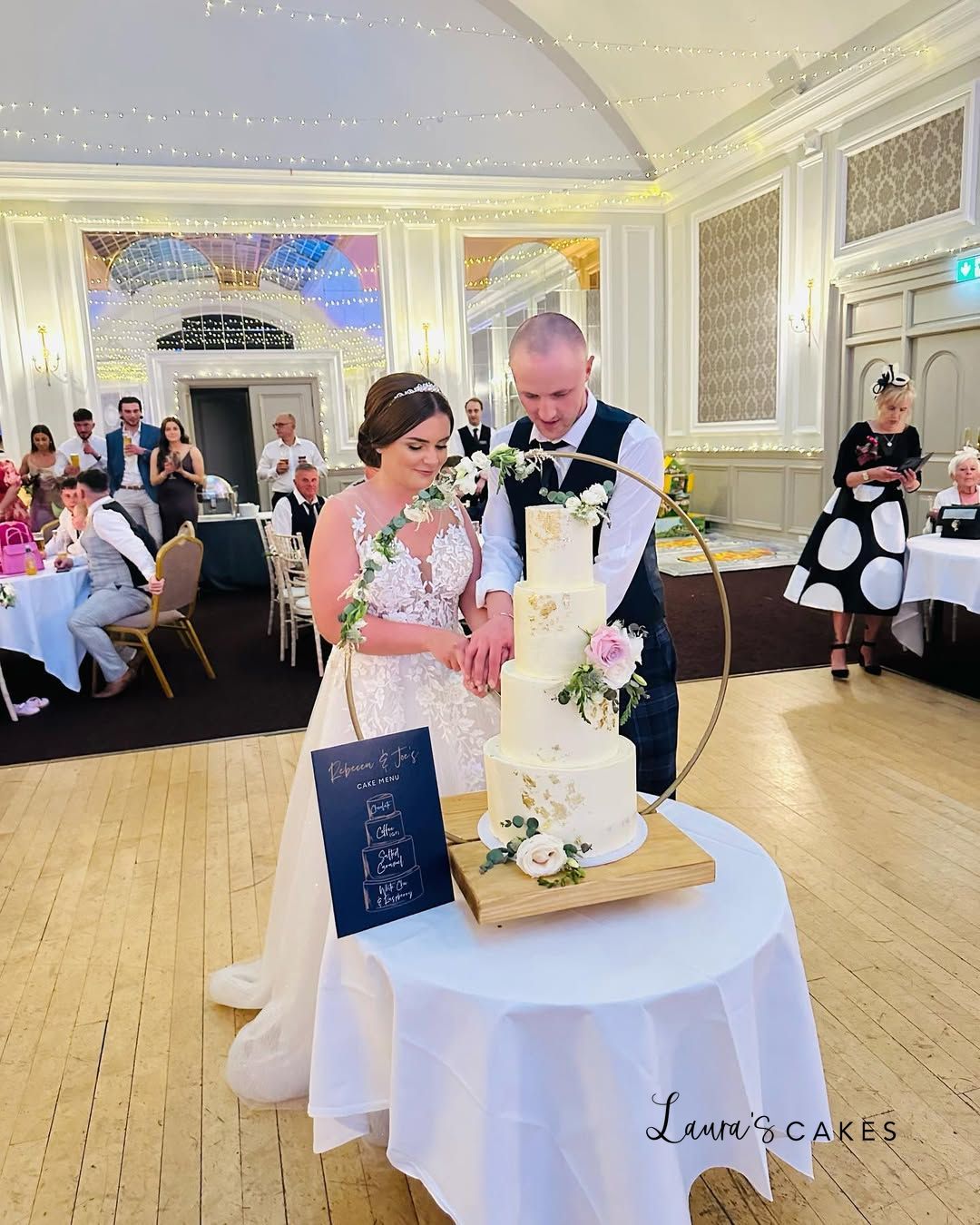 1-a-bride-and-groom-cutting-their-wedding-cake