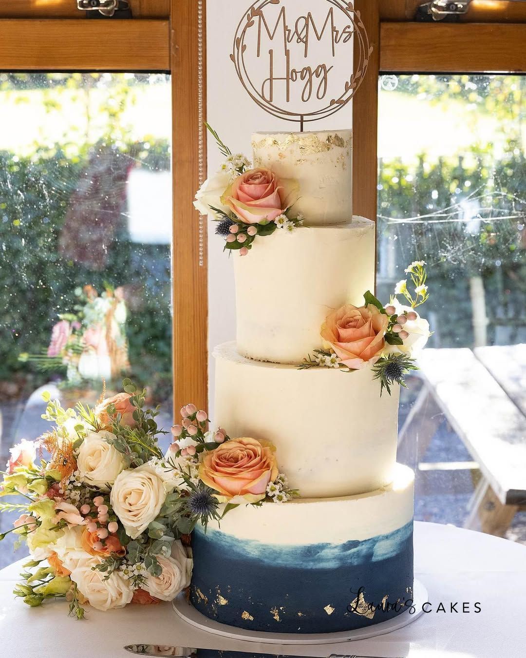 1-a-white-wedding-cake-with-a-blue-om-om-om-om-om-om