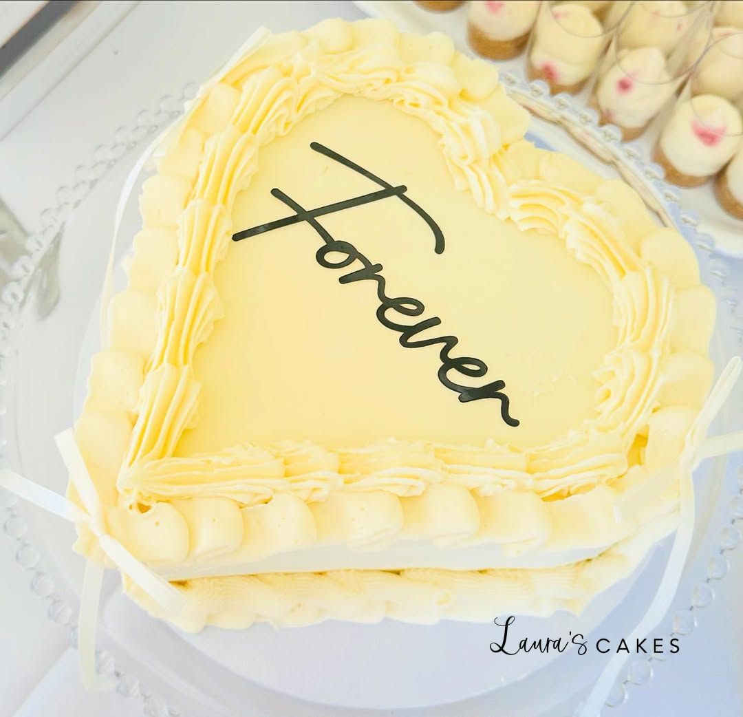 Wedding cake: A heart shaped cake with the word love on it