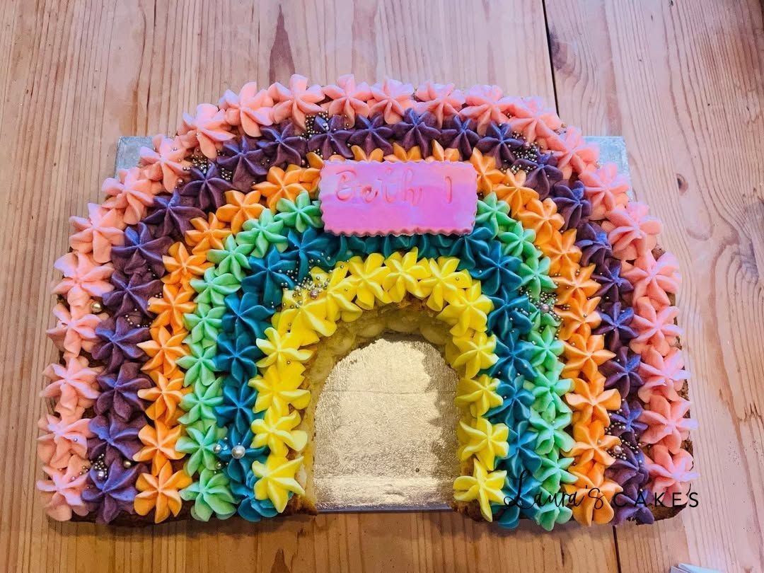 Celebration cake: A rainbow cake with a rainbow shaped cake top
