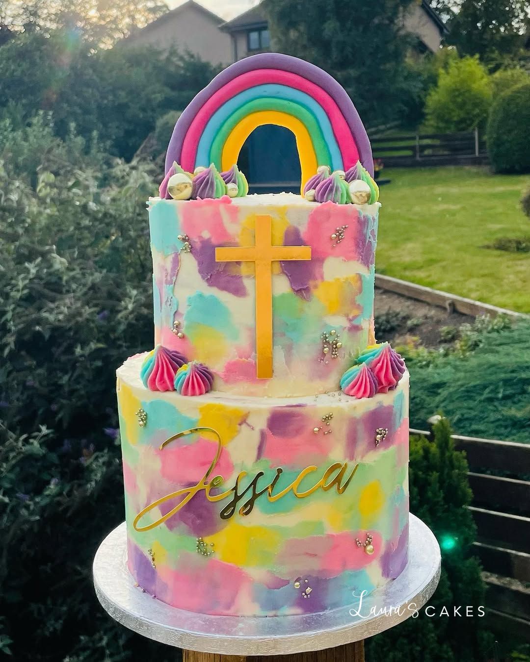Celebration cake: A rainbow theme and a cross on top