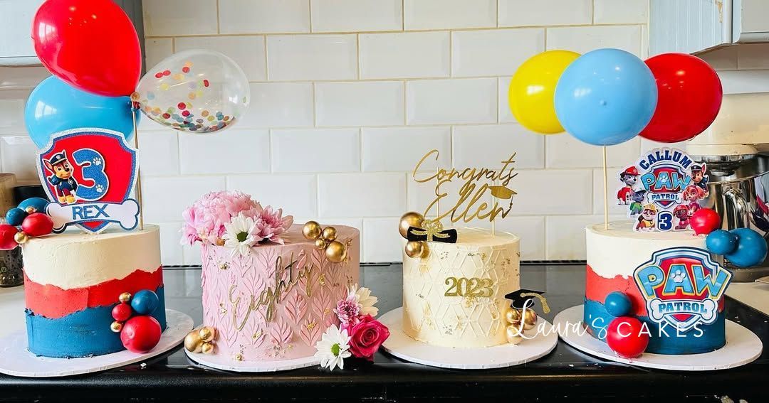 Celebration cake: A table topped with three cakes and balloons