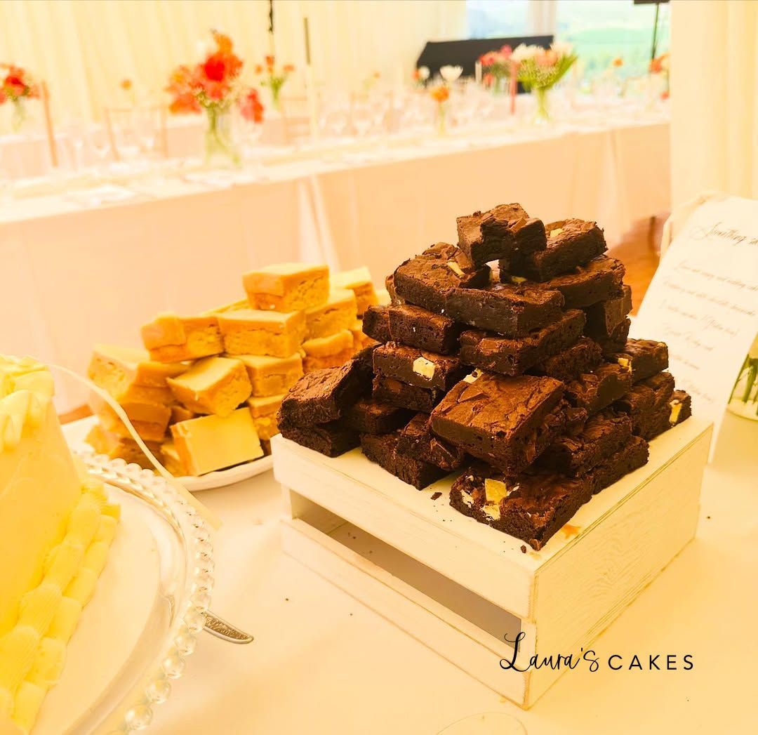 Wedding cake: A table with a bunch of chocolates and a plate of cheese