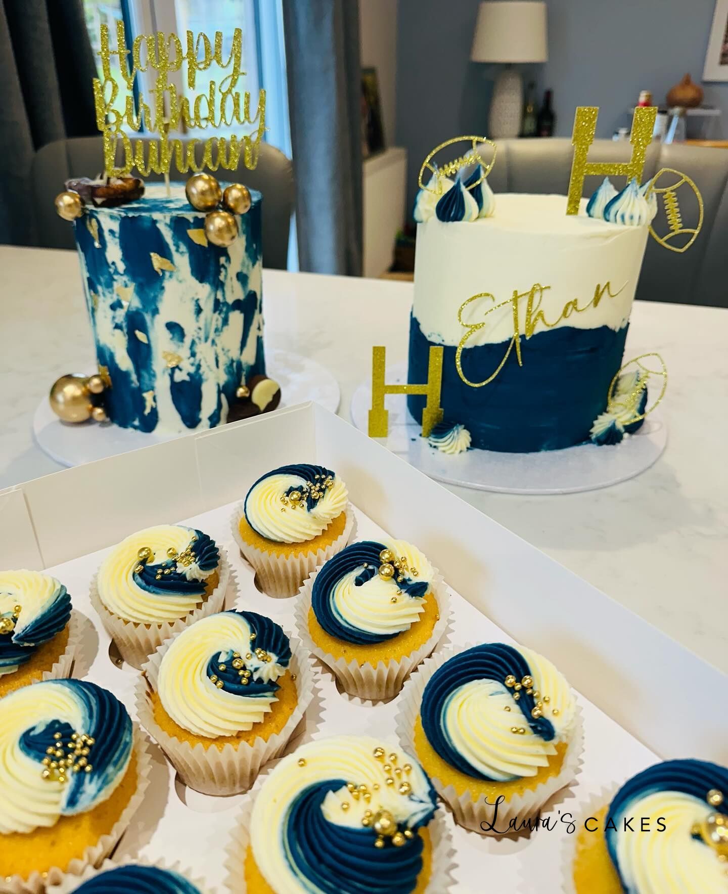 Celebration cake: A table with cupcakes and a cake
