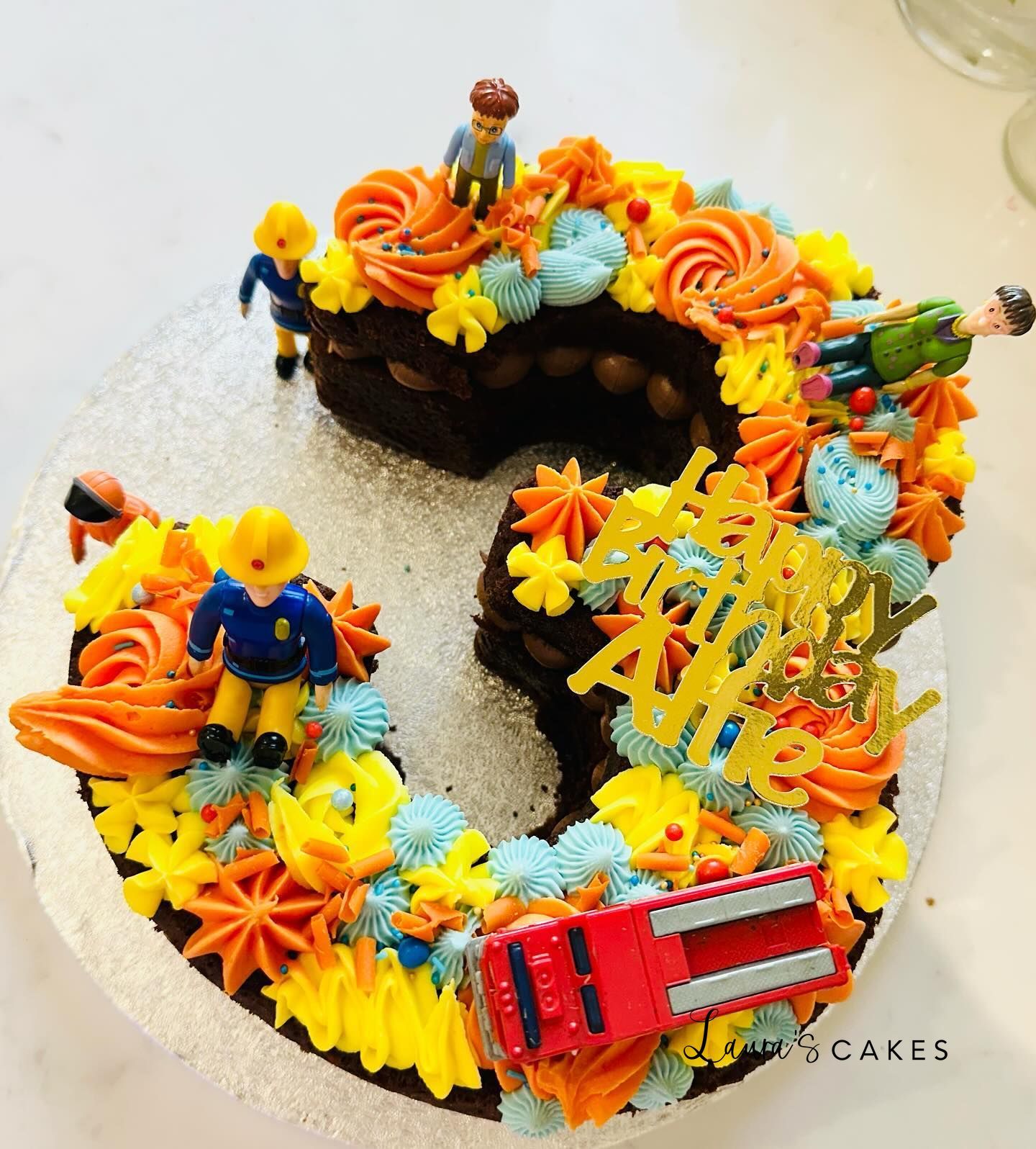 Celebration cake: A toy truck and a cake topper