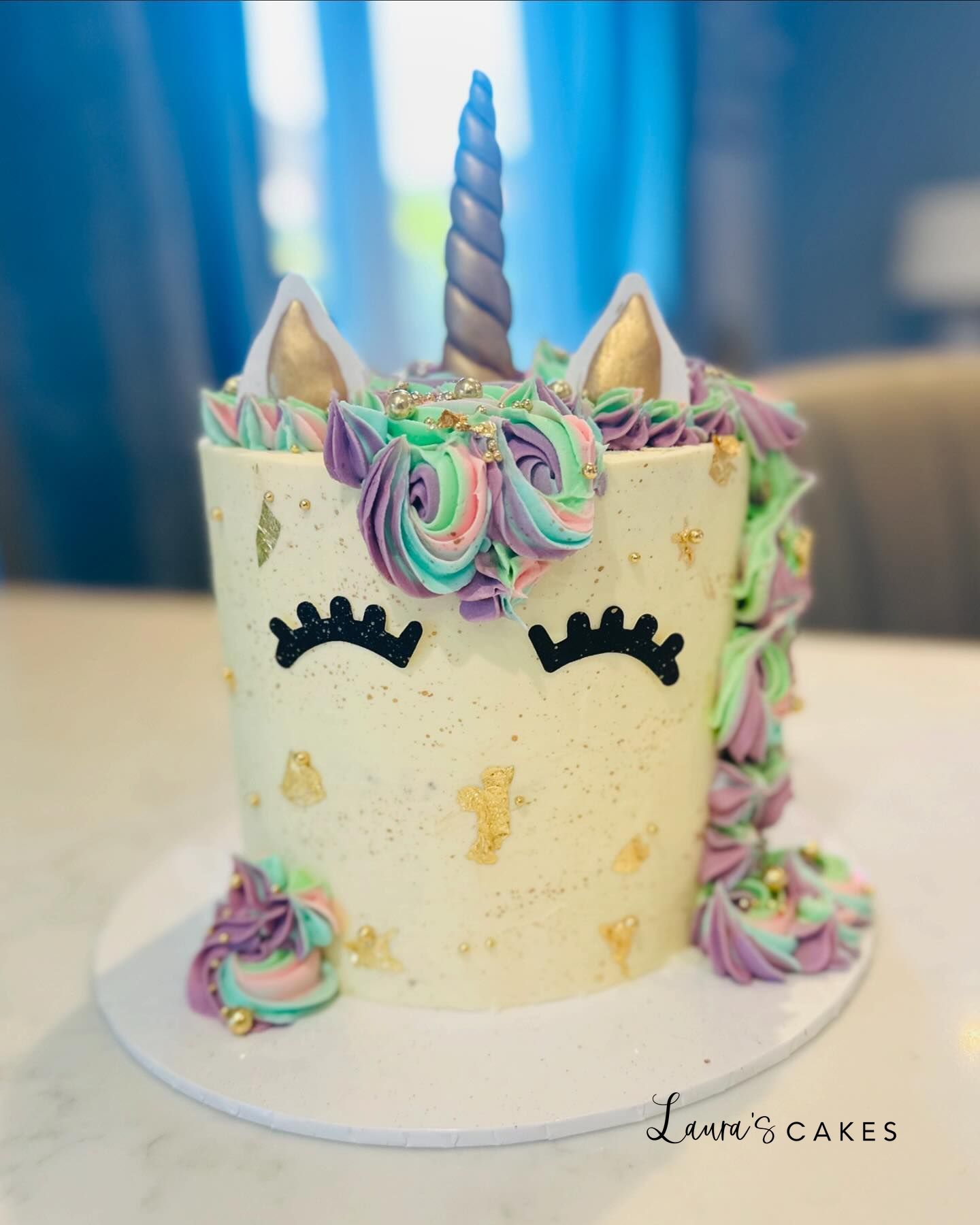 Celebration cake: A unicorn cake with a unicorn face on top