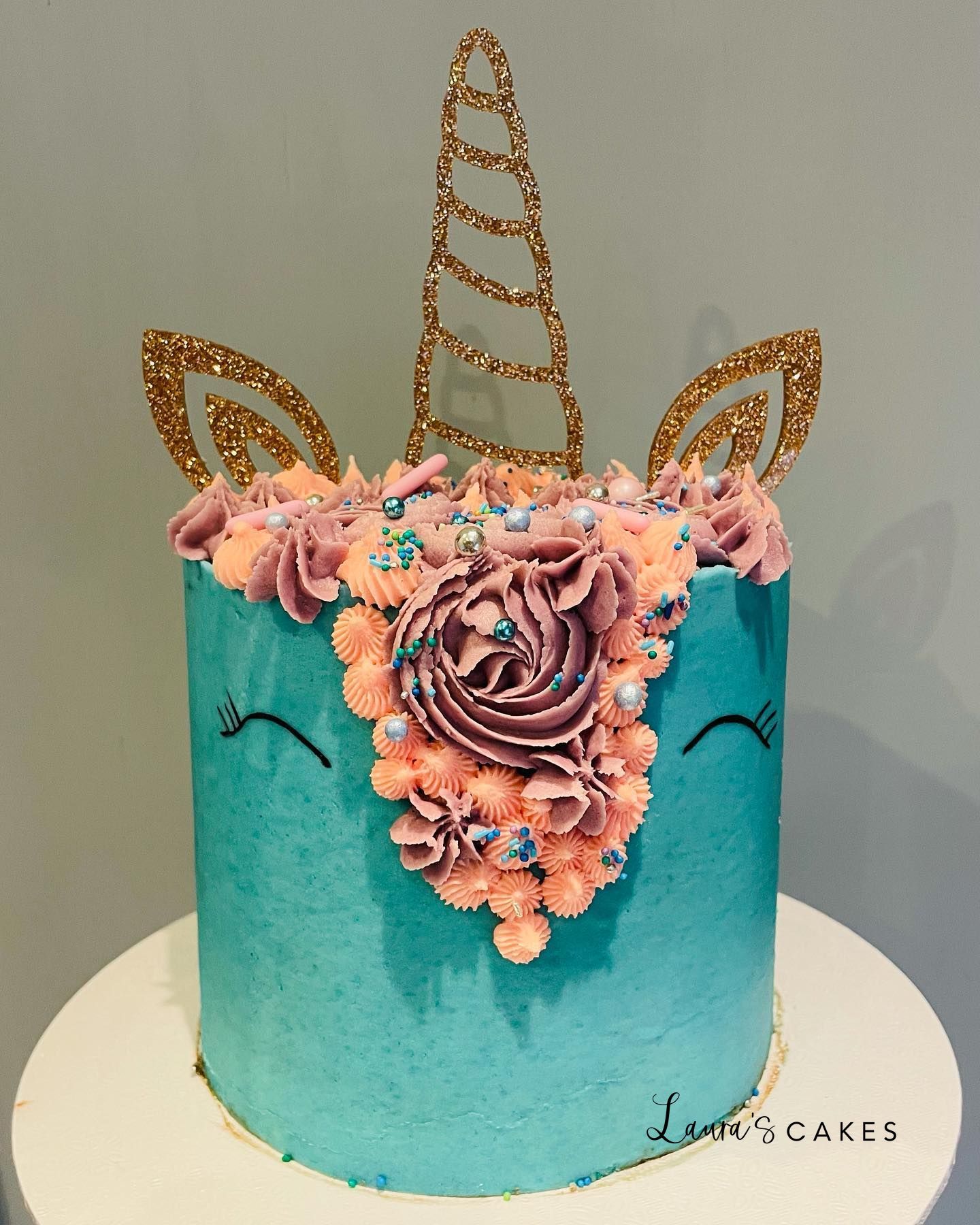Celebration cake: A unicorn head on top
