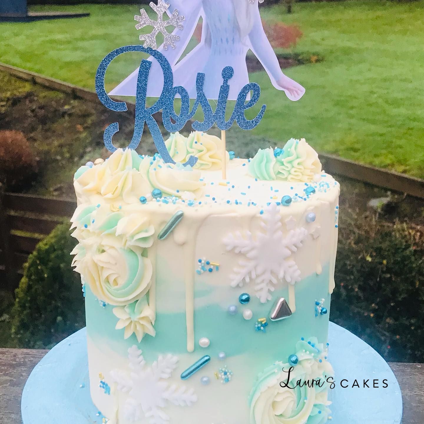 Celebration cake: A unicorn on top and flowers