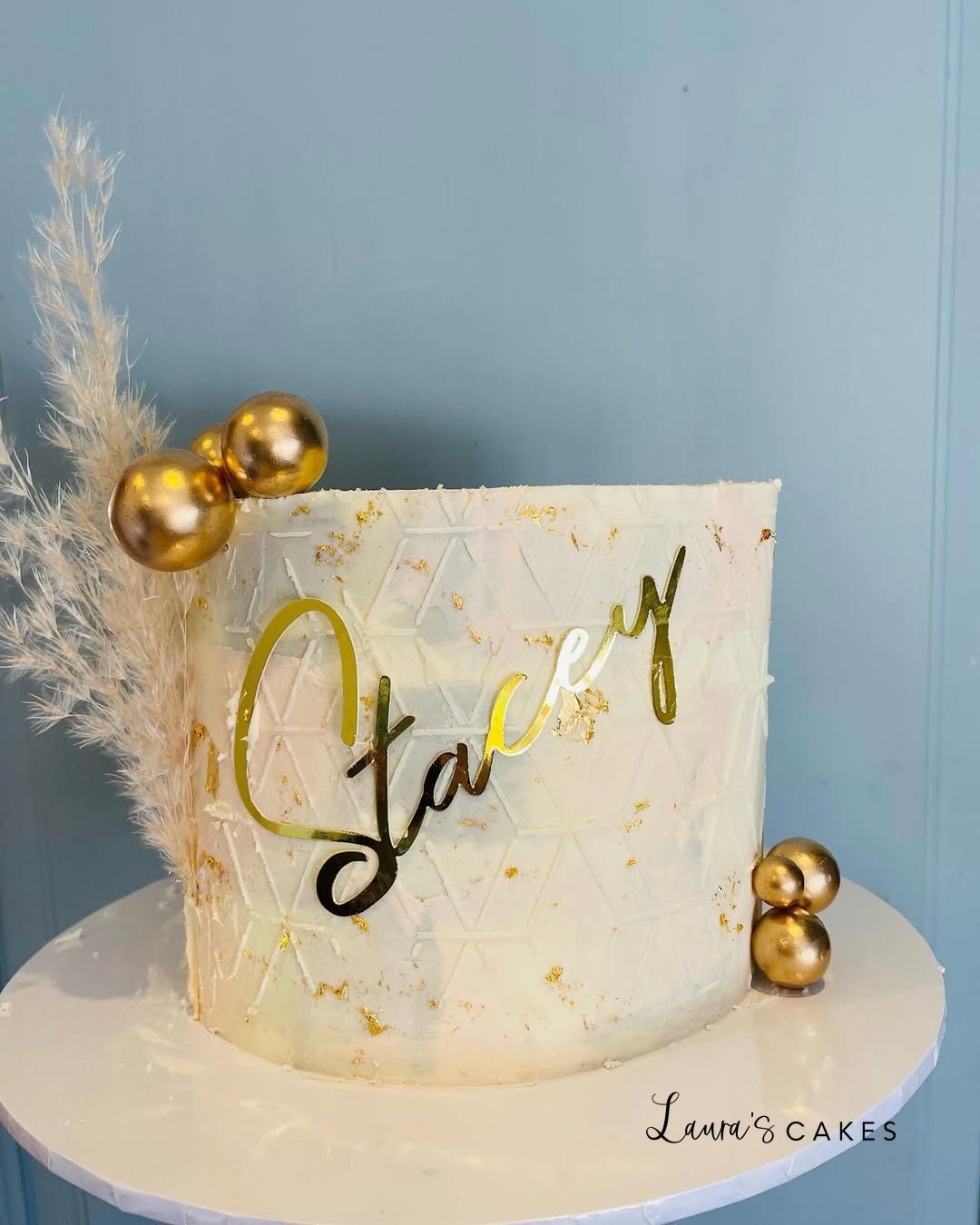 Celebration cake: A white cake with gold foil and a gold foil on top