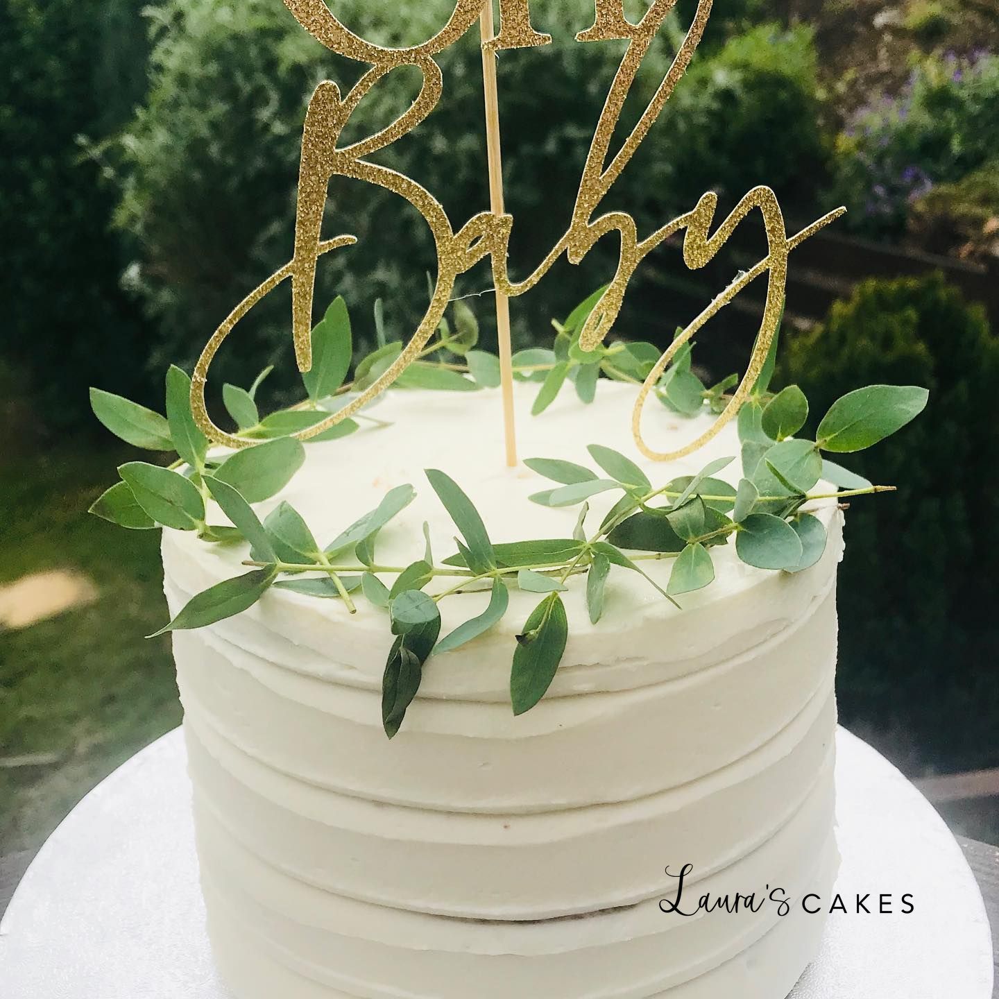 Celebration cake: A white cake with gold glitter and greene on top
