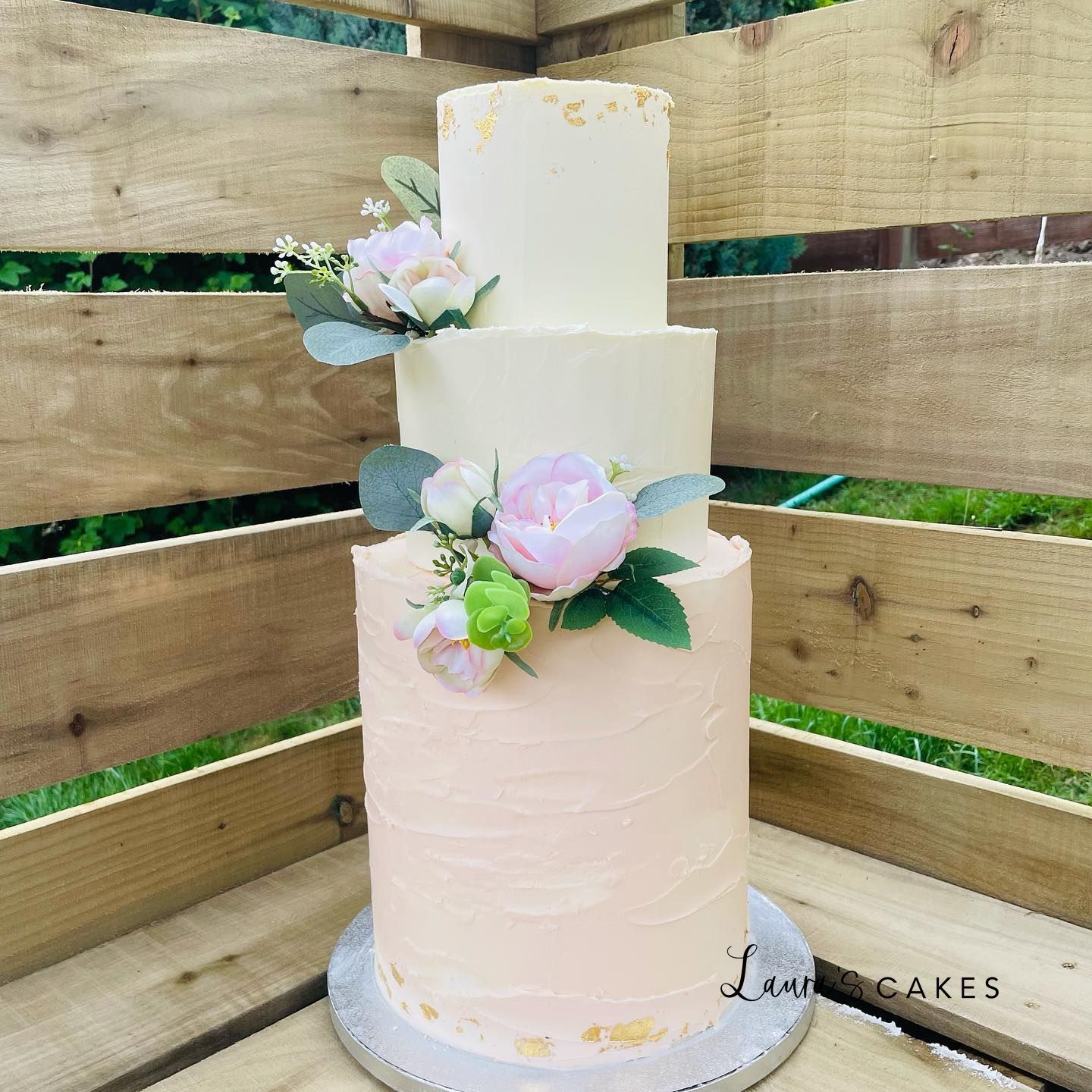 Wedding cake: A white cake with pink flowers on top