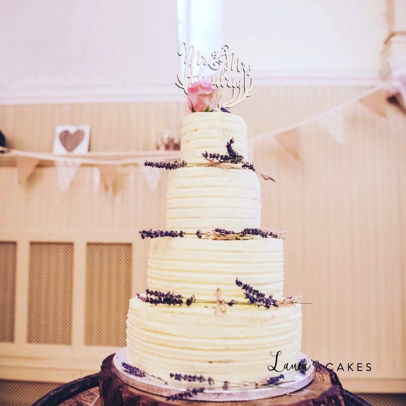 Wedding cake: A white frosting and purple flowers