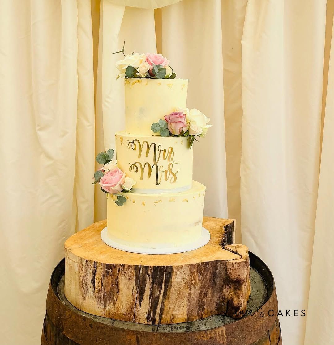 Wedding cake: A white wedding cake with pink flowers on top