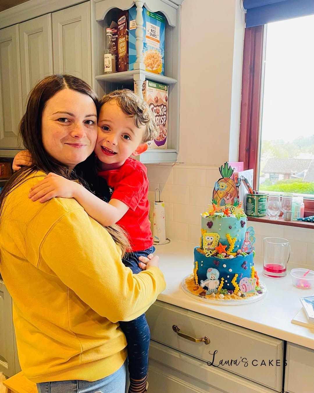 Celebration cake: A woman holding a child in her arms