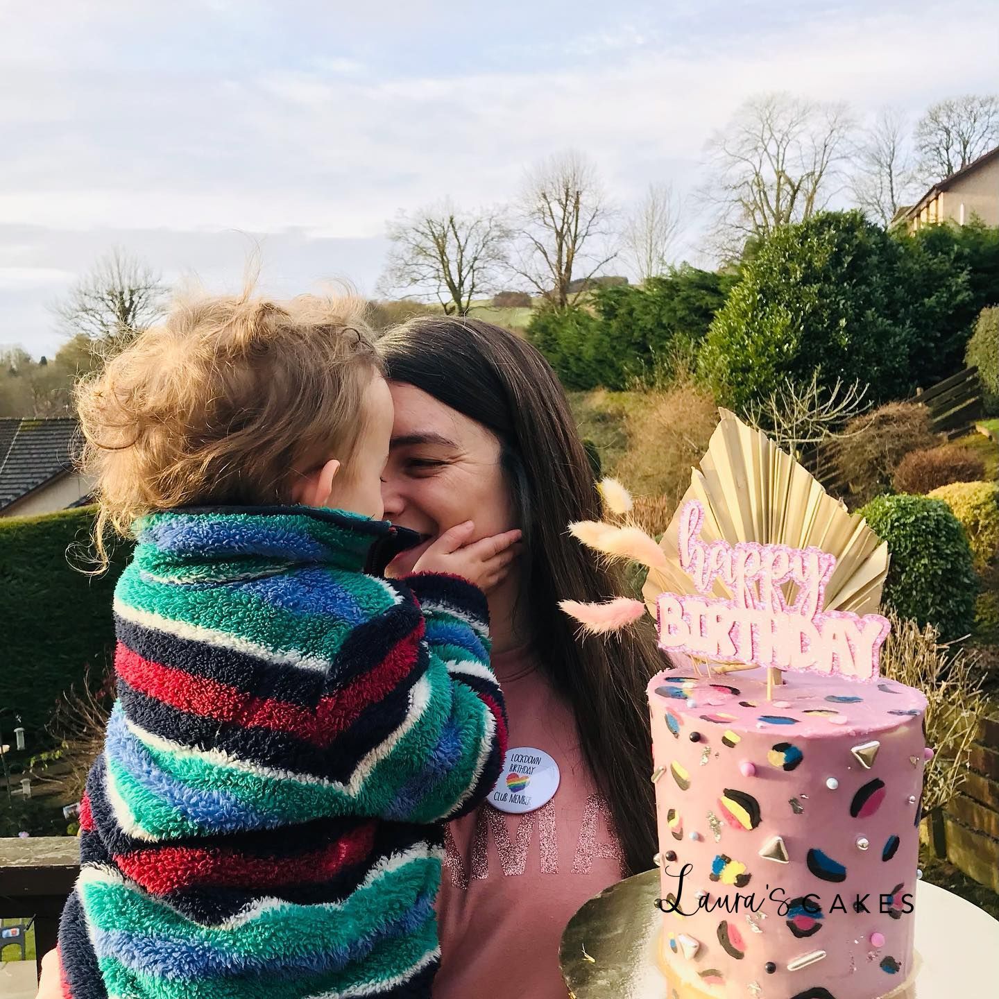 Celebration cake: A woman kissing a child on the cheek