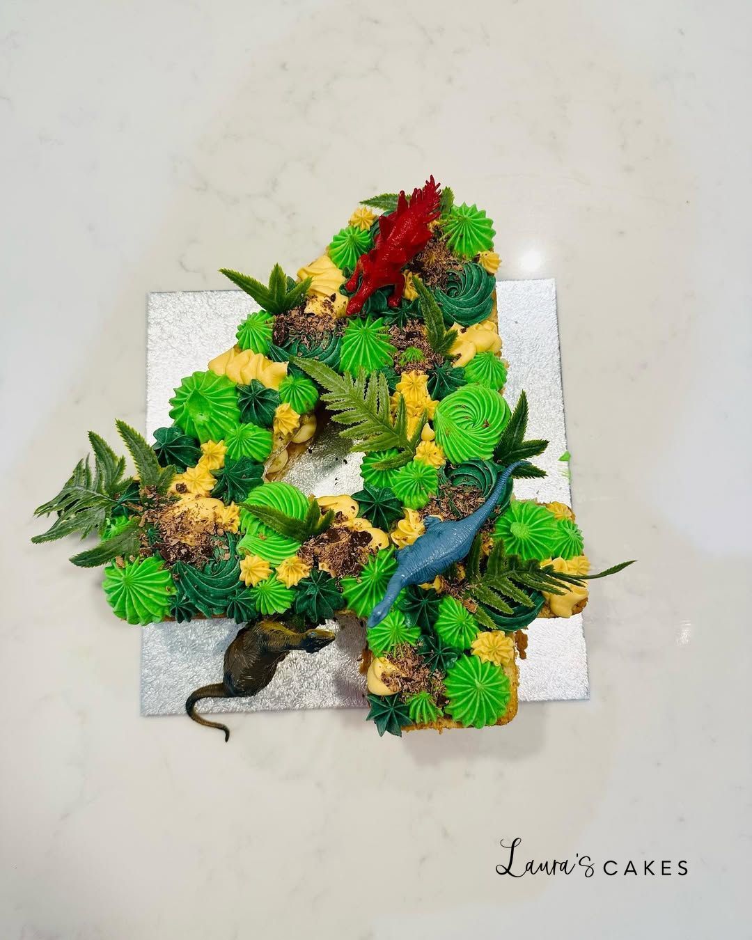 Celebration cake: A wreath made out of green leaves and yellow flowers