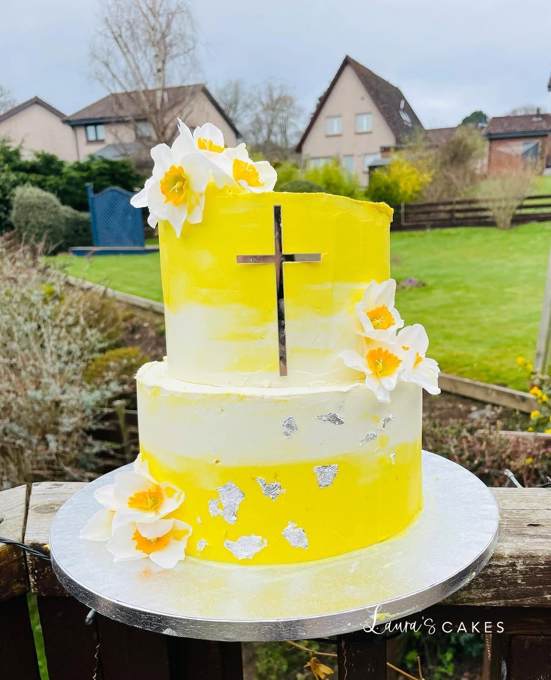 Celebration cake: A yellow cake with white flowers on top