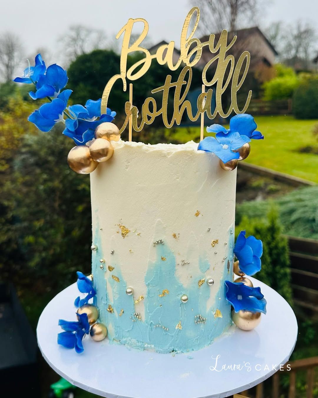 Celebration cake: Blue and gold decorations on top