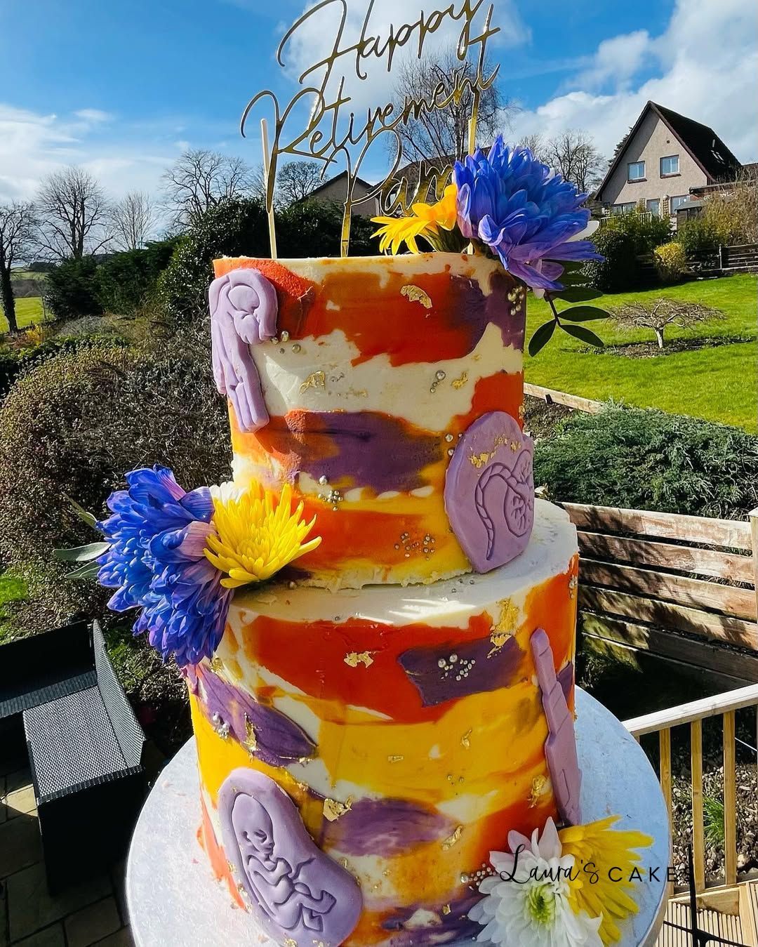 Celebration cake: Flowers and a sign on top