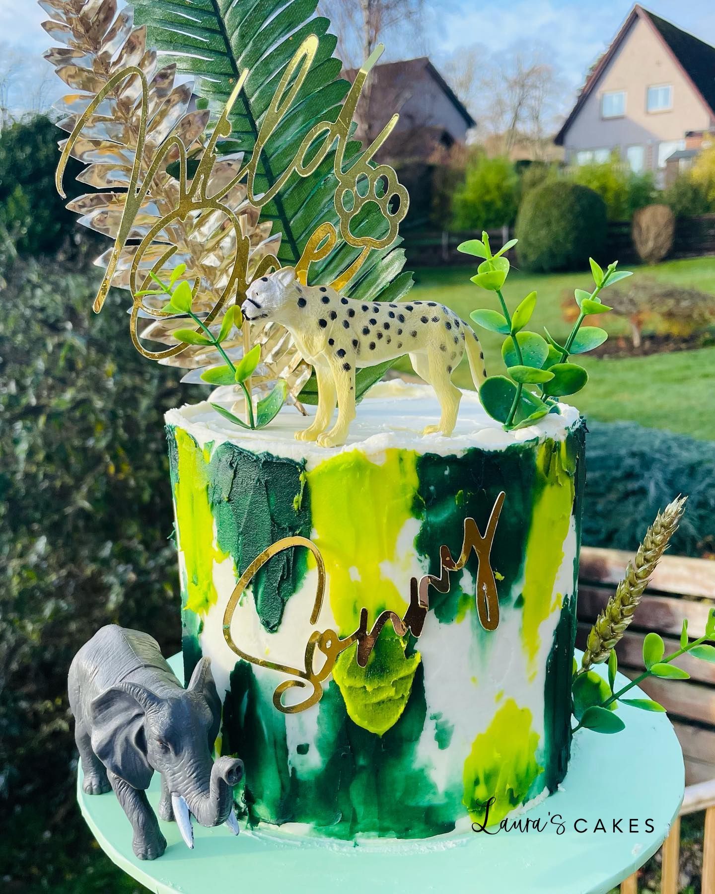 Celebration cake: Green and yellow paint and a small elephant