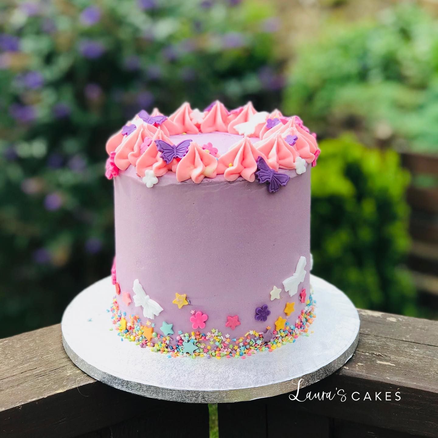 Celebration cake: Pink frosting and colorful flowers